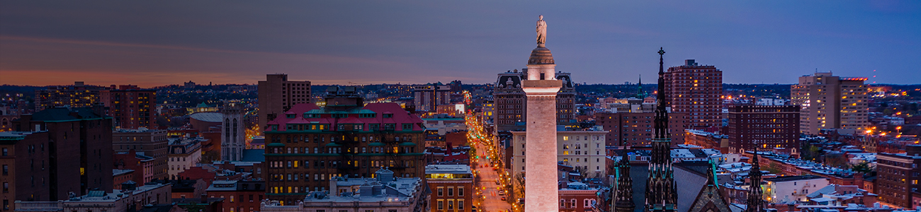 1. A tall monument stands prominently in the center of a bustling city, surrounded by buildings and pedestrians.