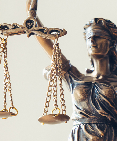 A statue of Lady Justice, blindfolded, holding balanced scales in her hands, symbolizing fairness and impartiality.